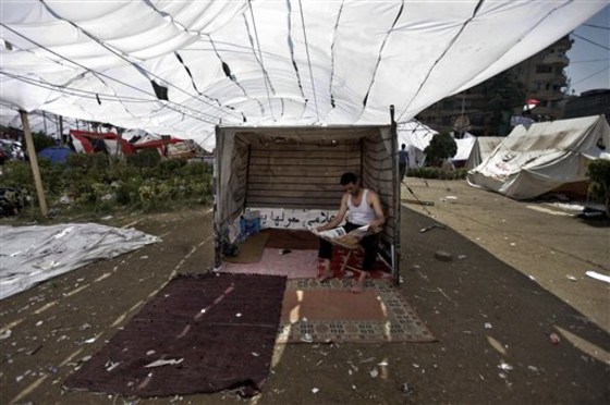 An Egyptian demonstrator reads the newspaper July 9 as he sits in a tent during a second day of protests in Tahrir Square in Cairo, Egypt. What appeared an unstoppable groundswell for change across the Middle East earlier this year, has splintered into scattered and indecisive conflicts that have left thousands dead and Western policy makers juggling roles.